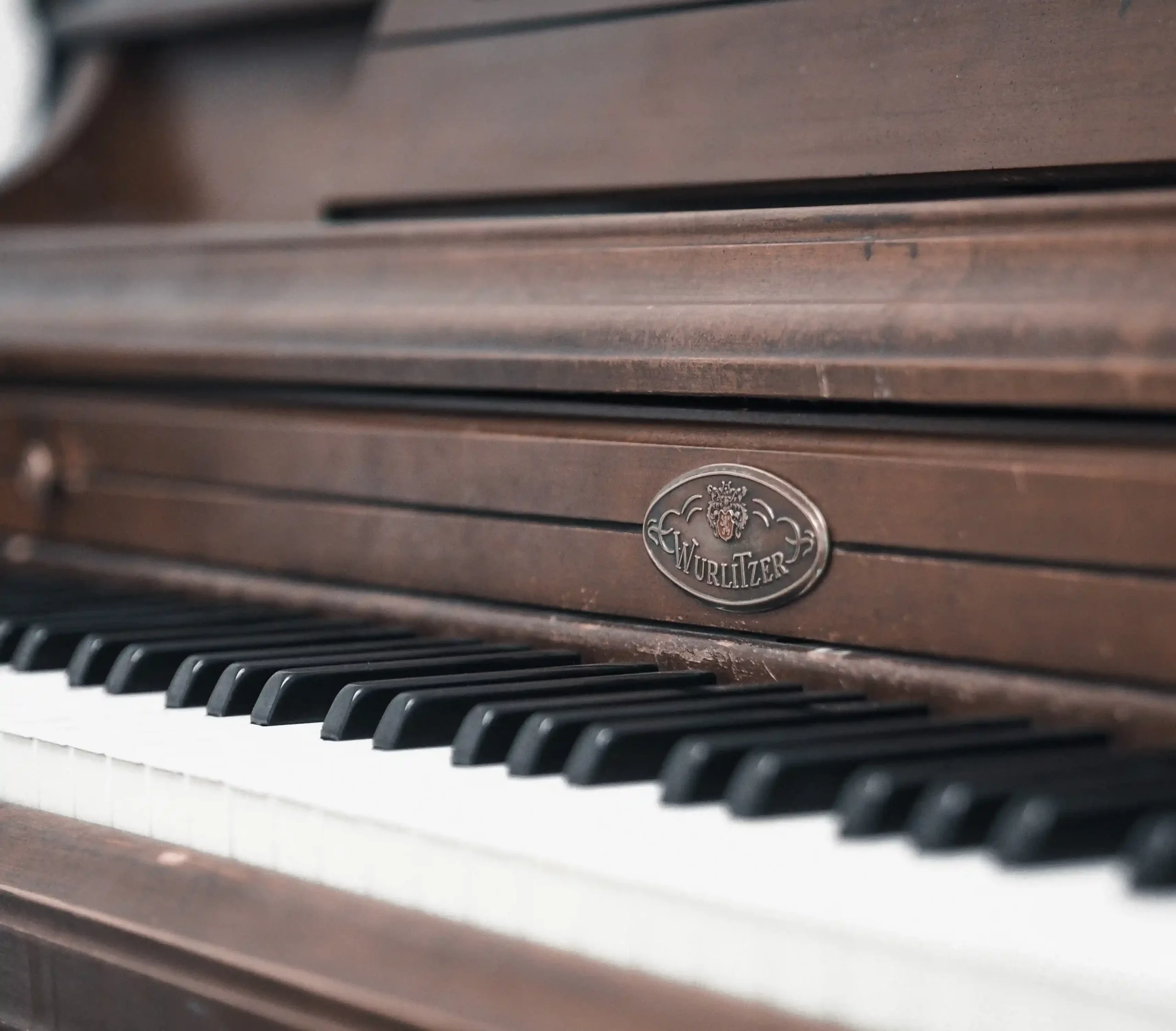 Close-up of a Wurlitzer piano, showcasing our piano moving expertise.