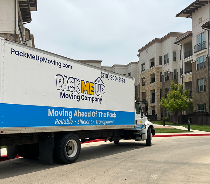 Moving truck parked at an apartment complex, ready for efficient moving services.